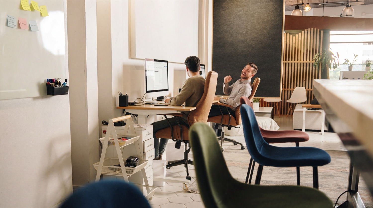 Two designers at work in the Lightbox studio, laughing between screens.
